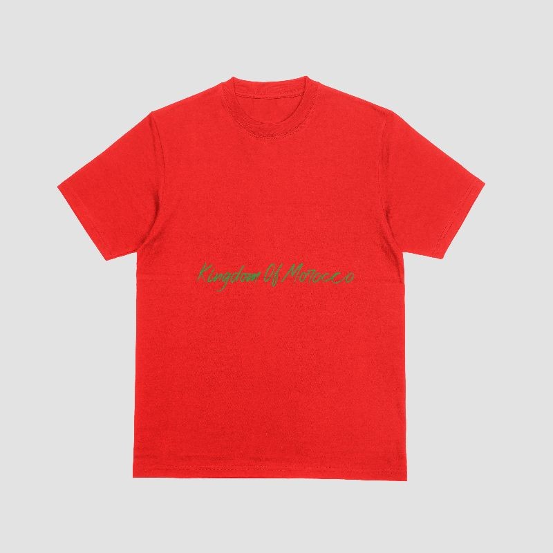 The image shows a bright red t-shirt with the text "Kingdom Of Morocco" printed on it in a stylized, cursive-like font. The text is written in a light green color, providing a nice contrast against the vibrant red background of the shirt.  The design has a simple, yet eye-catching aesthetic that appears to be inspired by Moroccan or North African cultural influences. The use of the cursive-style font for the text adds a touch of elegance and sophistication to the overall look.  The t-shirt seems to be a promotional or souvenir item that celebrates the Kingdom of Morocco, likely intended for tourists or those with an interest in Moroccan culture and heritage. The bold red color and the stylized text create a visually appealing and distinctive design that would stand out.